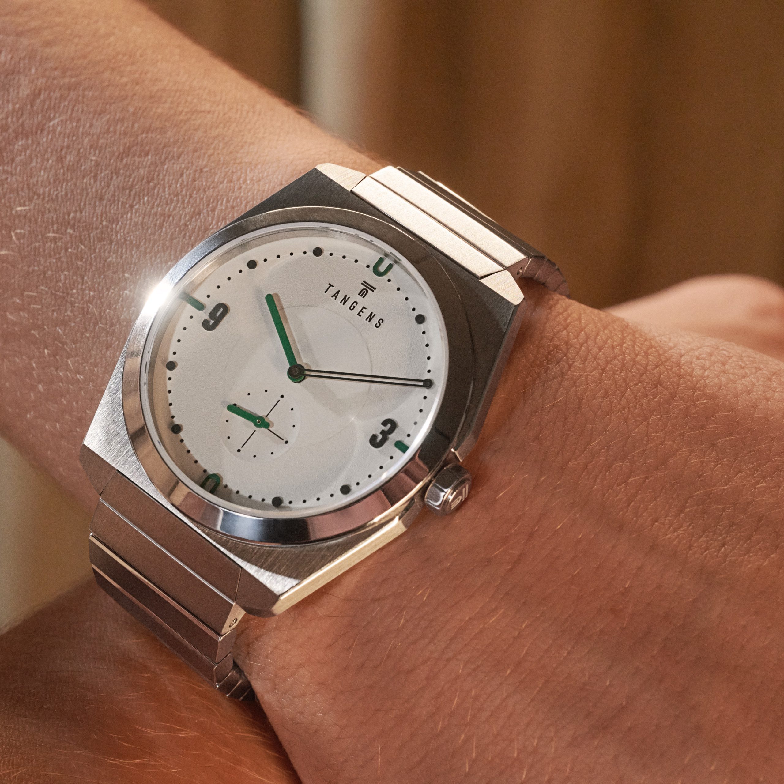 A Komposition Cream on a wrist, seen close from the side
